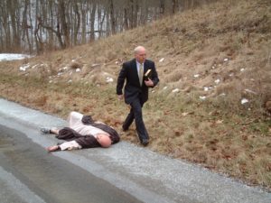 The modern priest passing by injured man